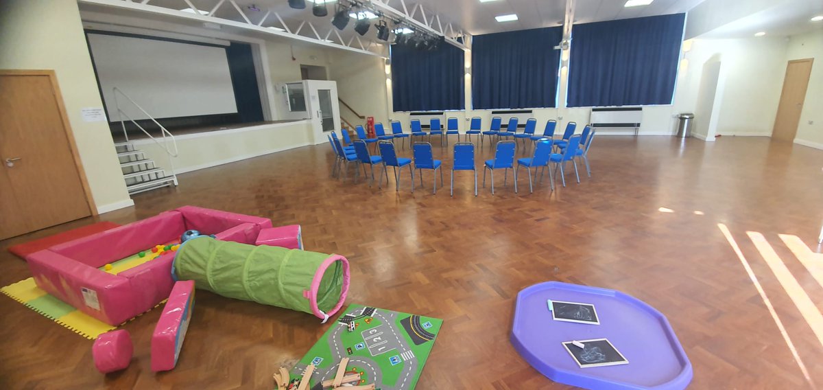 Versatile B12 Urban Village Hall with blue chairs for meetings and family-friendly events.