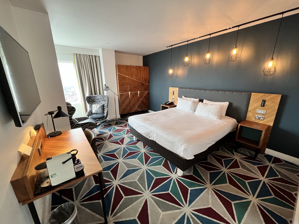 Modern hotel room with king-sized bed in The Cube Hotel Birmingham, perfect for events.