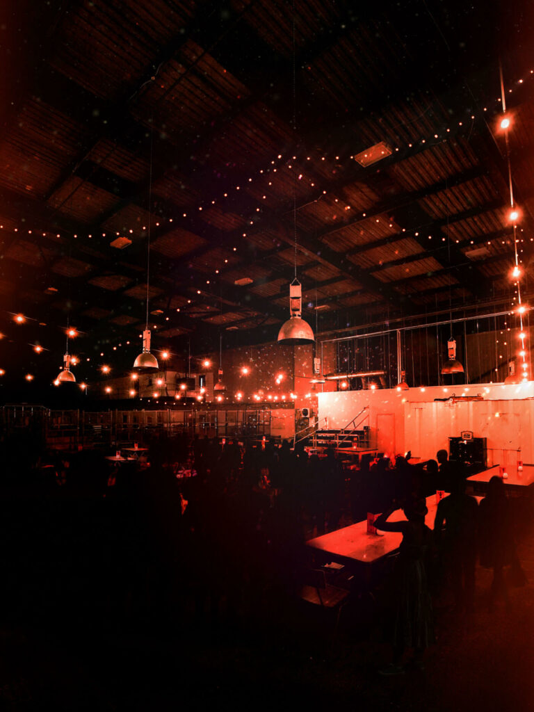 Caravans in Diecast: cozy industrial event space with warm lighting for gatherings.