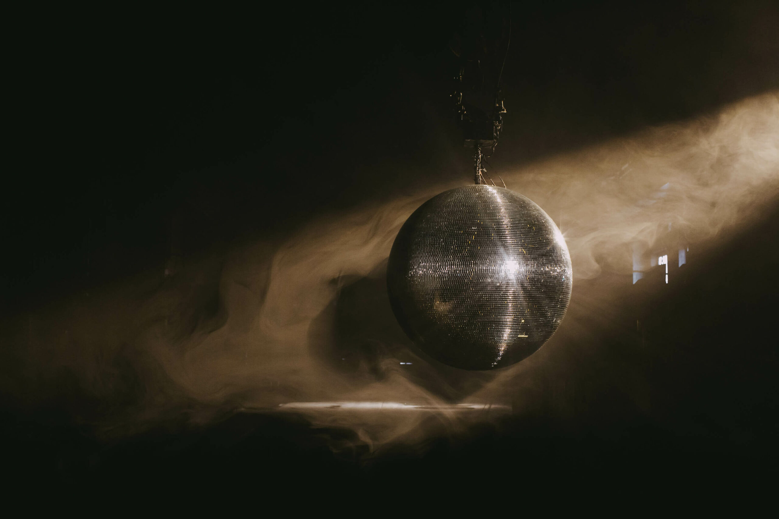 Disco ball with dramatic lighting for dynamic event themes and networking.