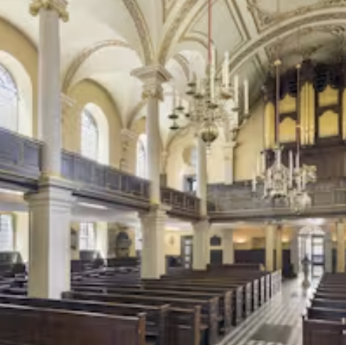 St Giles in the Fields Church event space with elegant chandeliers and natural light.