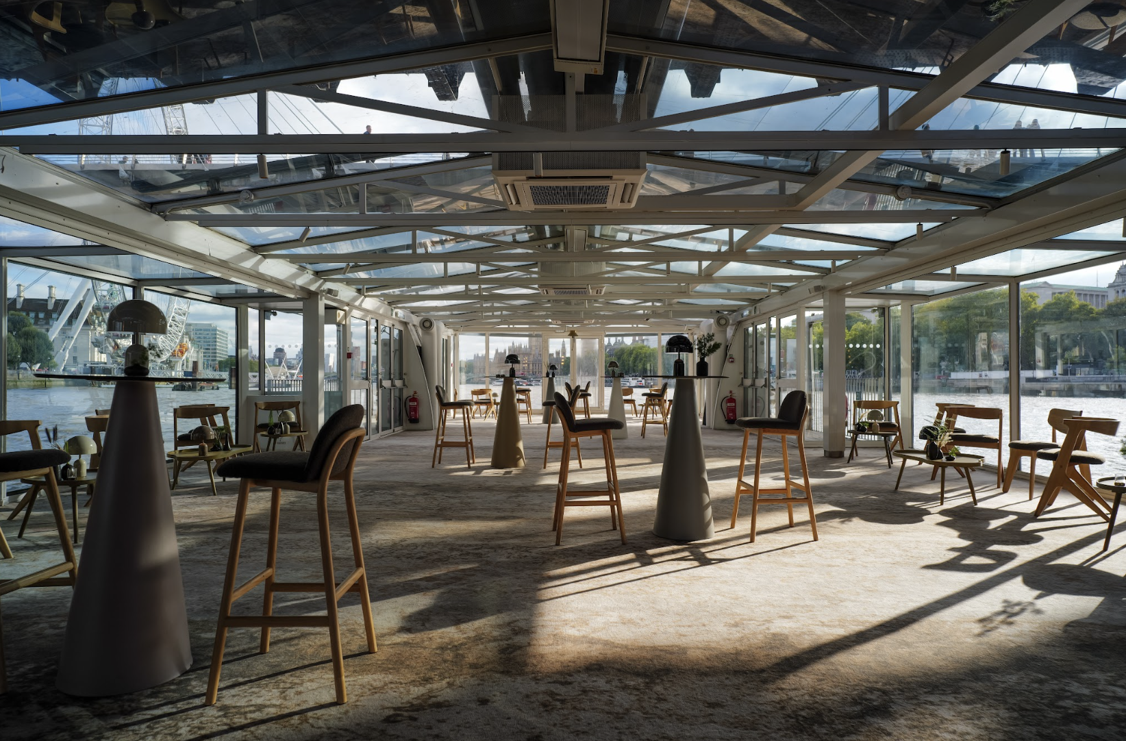 Modern event space with large windows, ideal for networking and cocktail receptions.