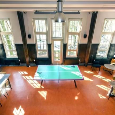 Spacious event space in Generator Amsterdam with ping pong table for team-building activities.