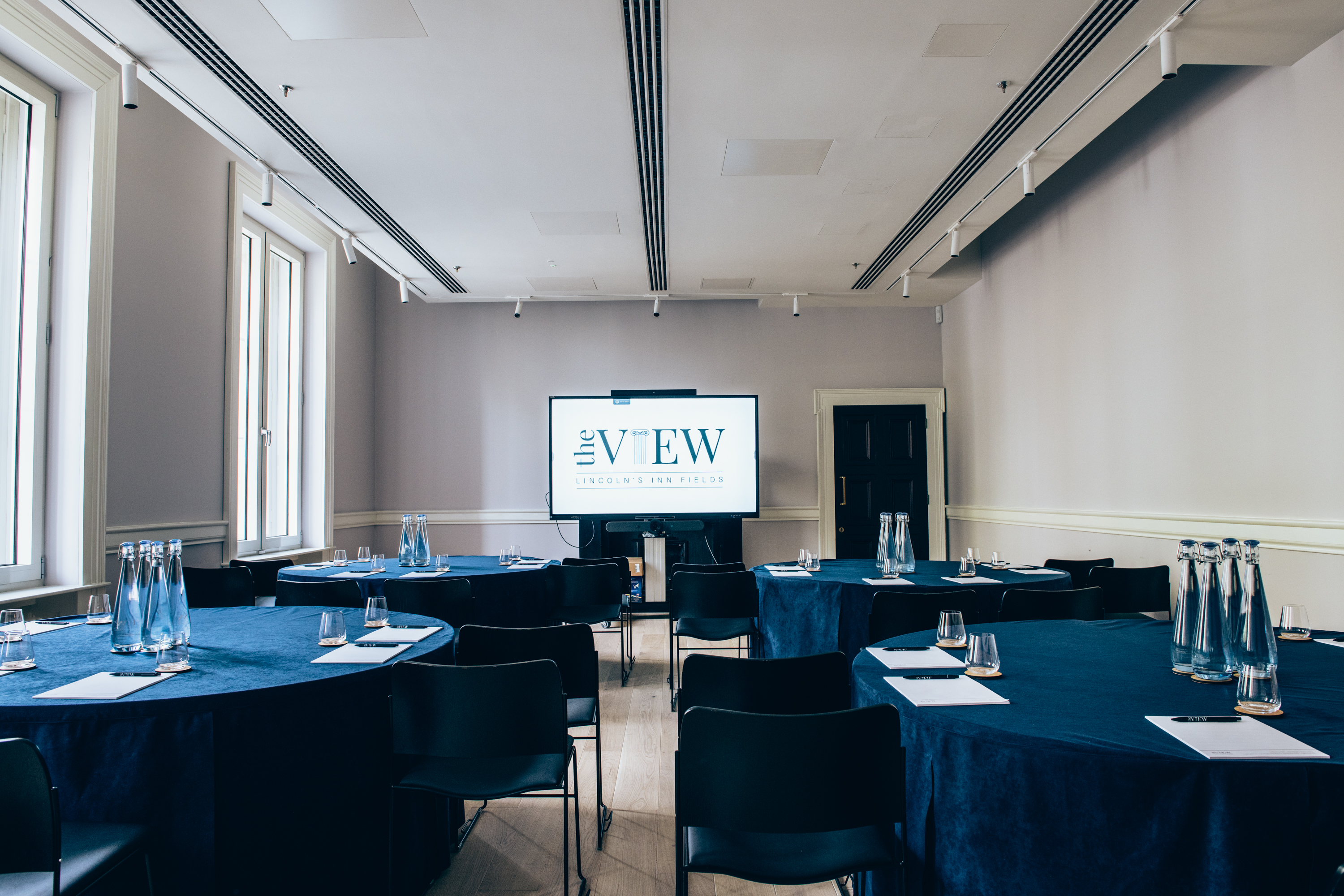 Meeting room with blue linens, ready for professional events and networking.