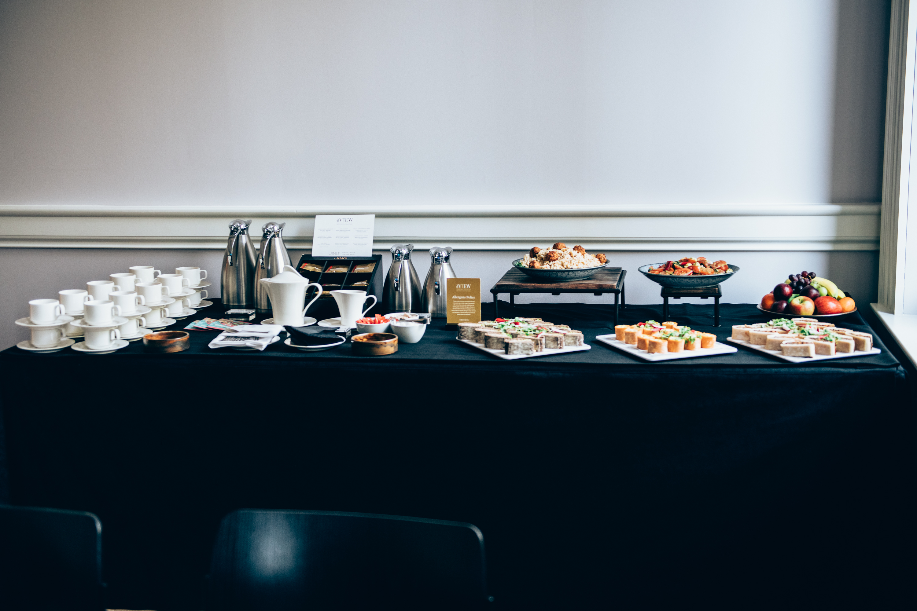 Refreshment station with coffee, tea, and pastries for meetings and events.