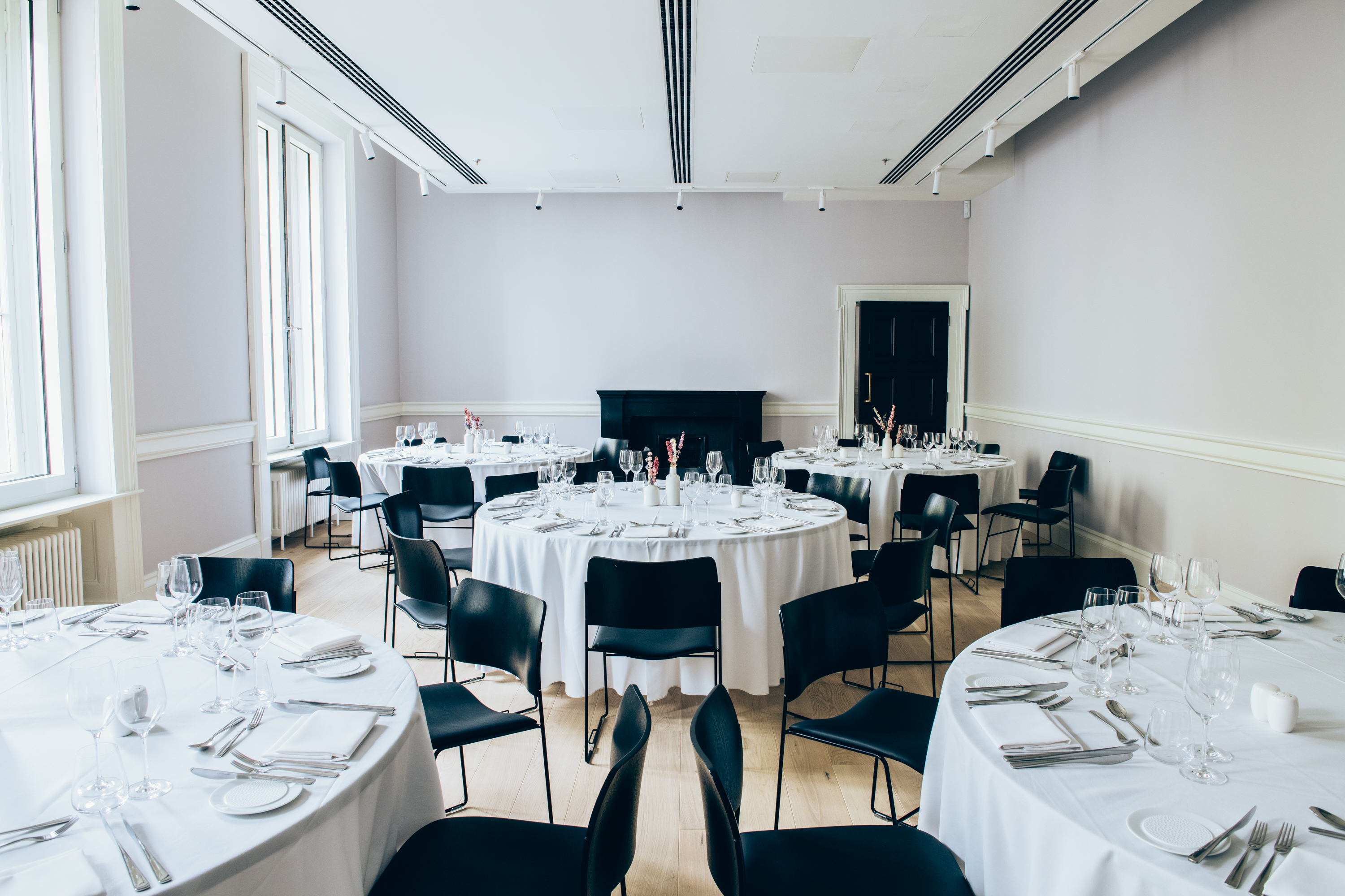 Elegant event space with round tables, ideal for corporate gatherings and celebrations.