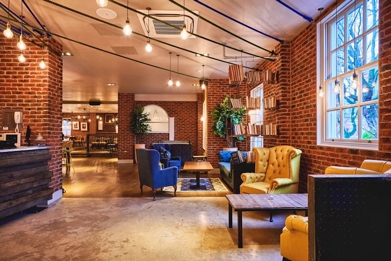 Private dining room at Saint Pauls House with warm brick walls, ideal for networking events.