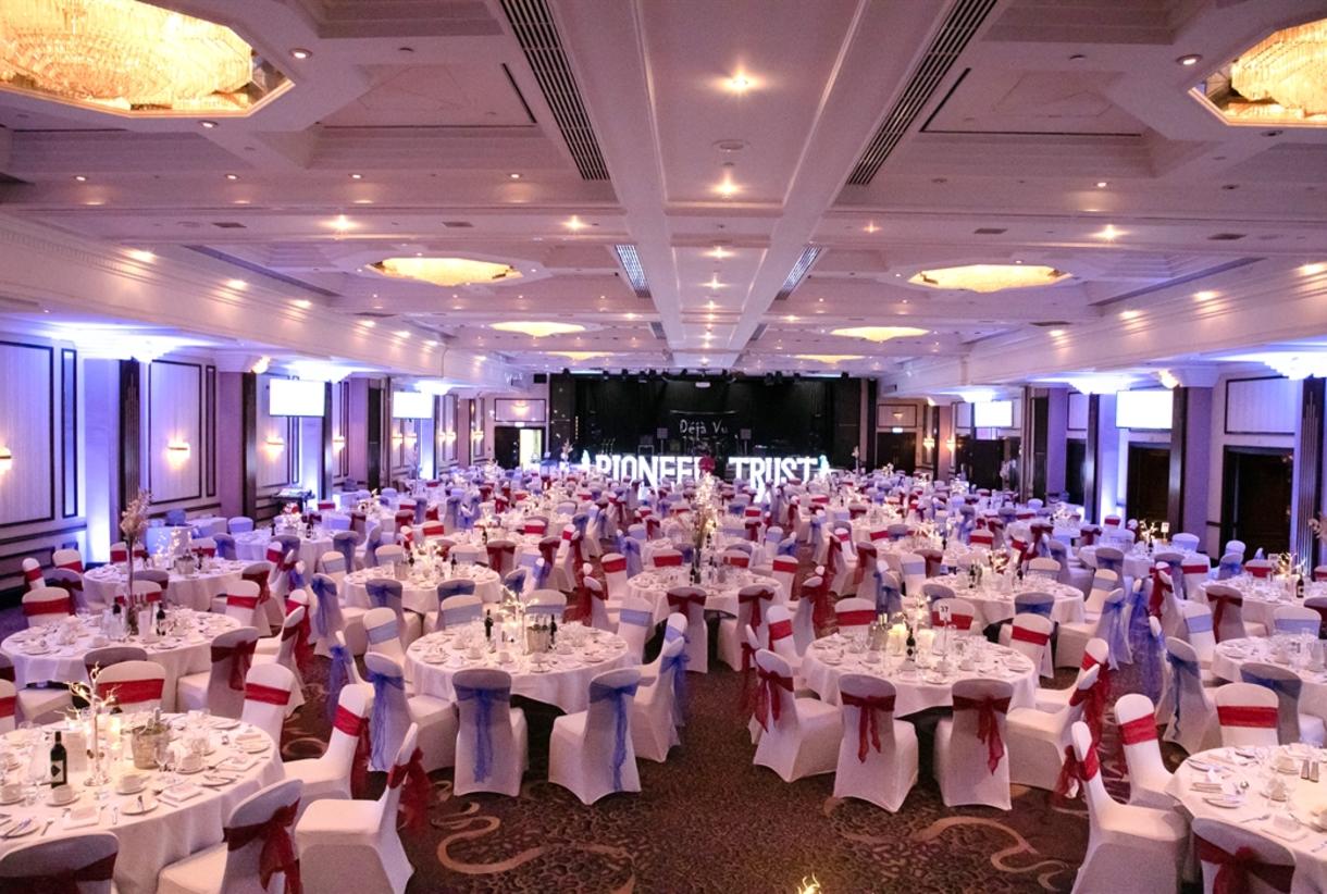 Elegant banquet hall with round tables, perfect for corporate events and weddings.