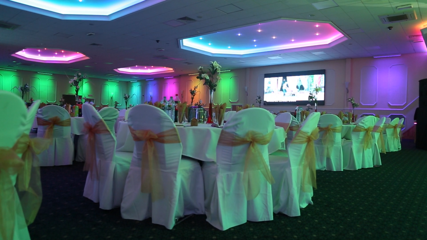 Elegant event space with draped tables, ideal for corporate gatherings and weddings.