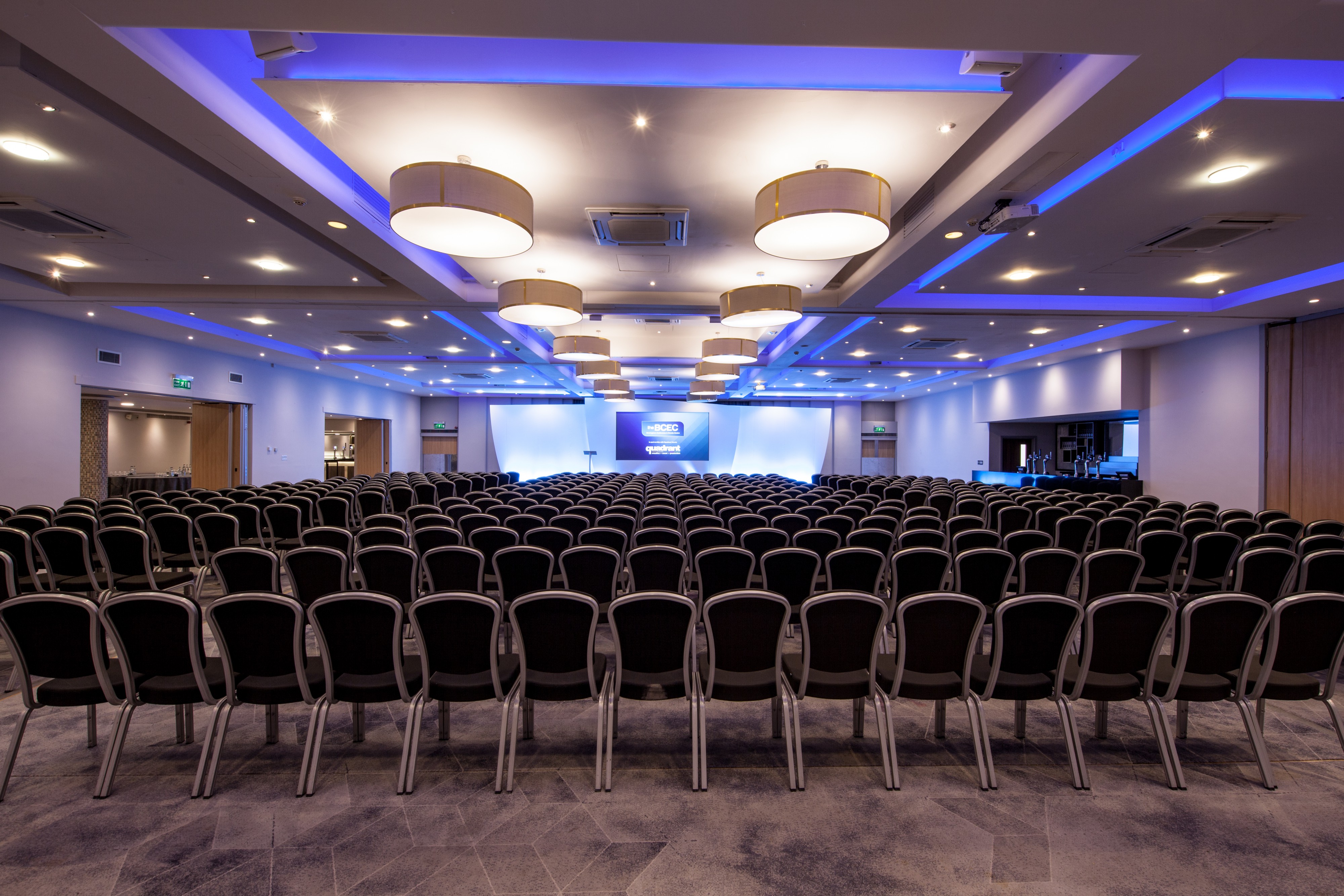 Spacious conference room with arranged chairs for corporate events and seminars.