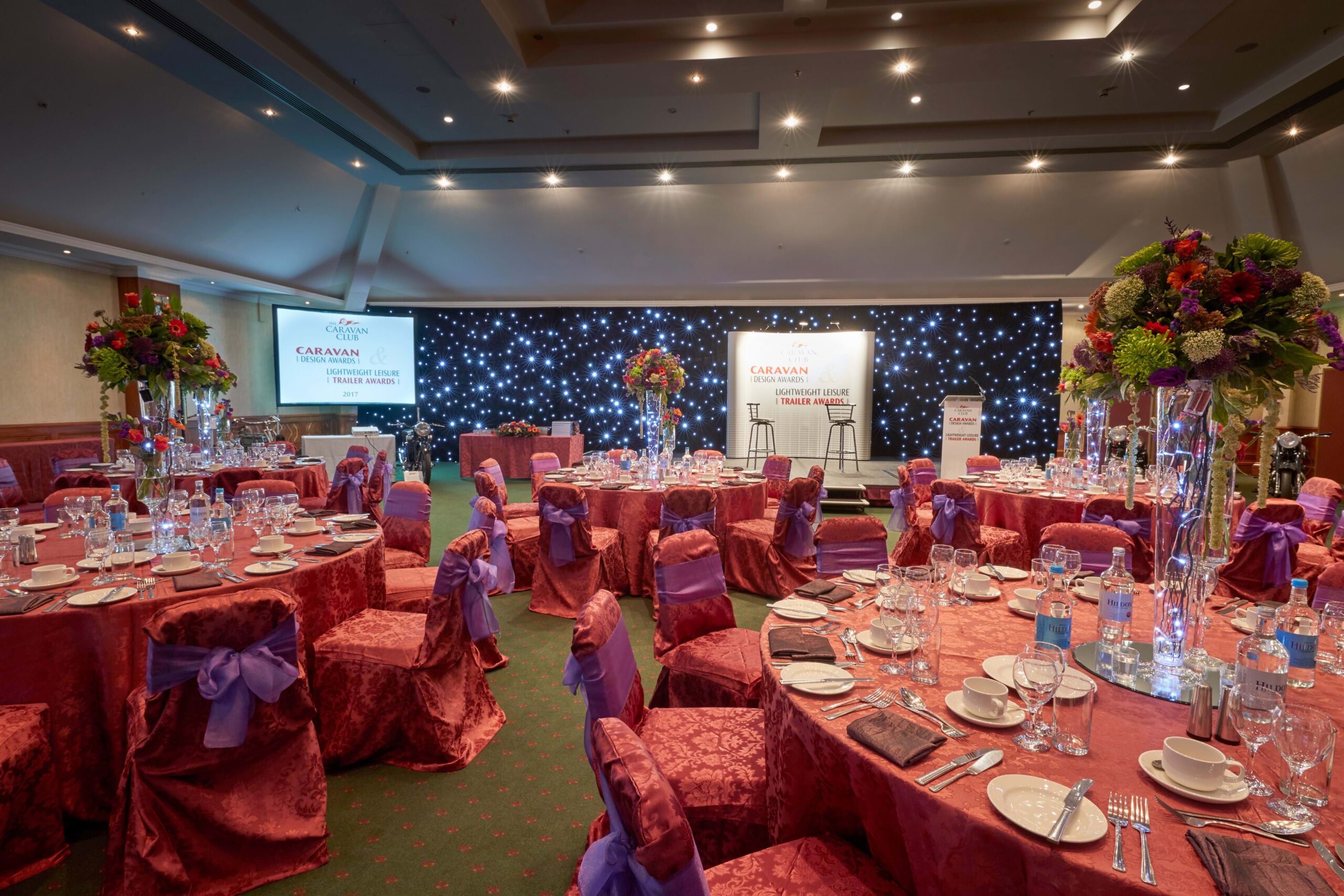 Elegant banquet hall with vibrant centerpieces for formal events and galas.