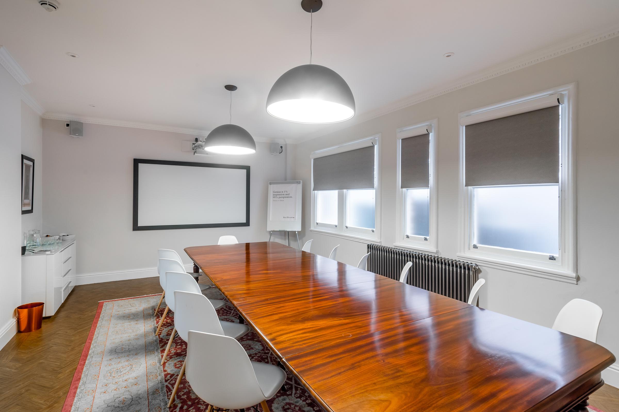 Modern conference room with wooden table, ideal for meetings and brainstorming sessions.