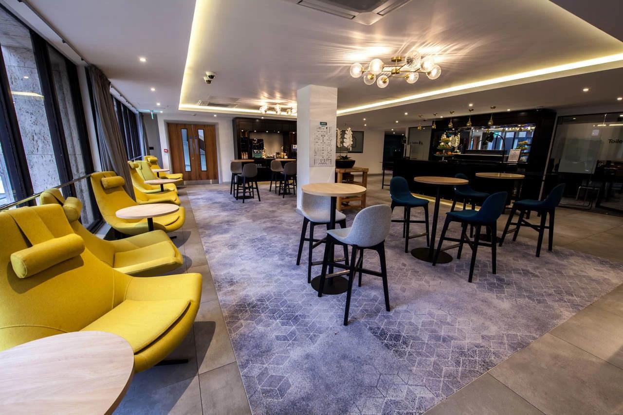 Modern BCEC meeting room with vibrant yellow chairs for workshops and networking.