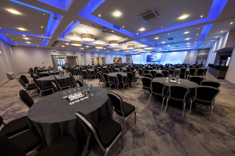 Mercian Suite at BCEC, spacious conference venue with elegant round tables and modern lighting.