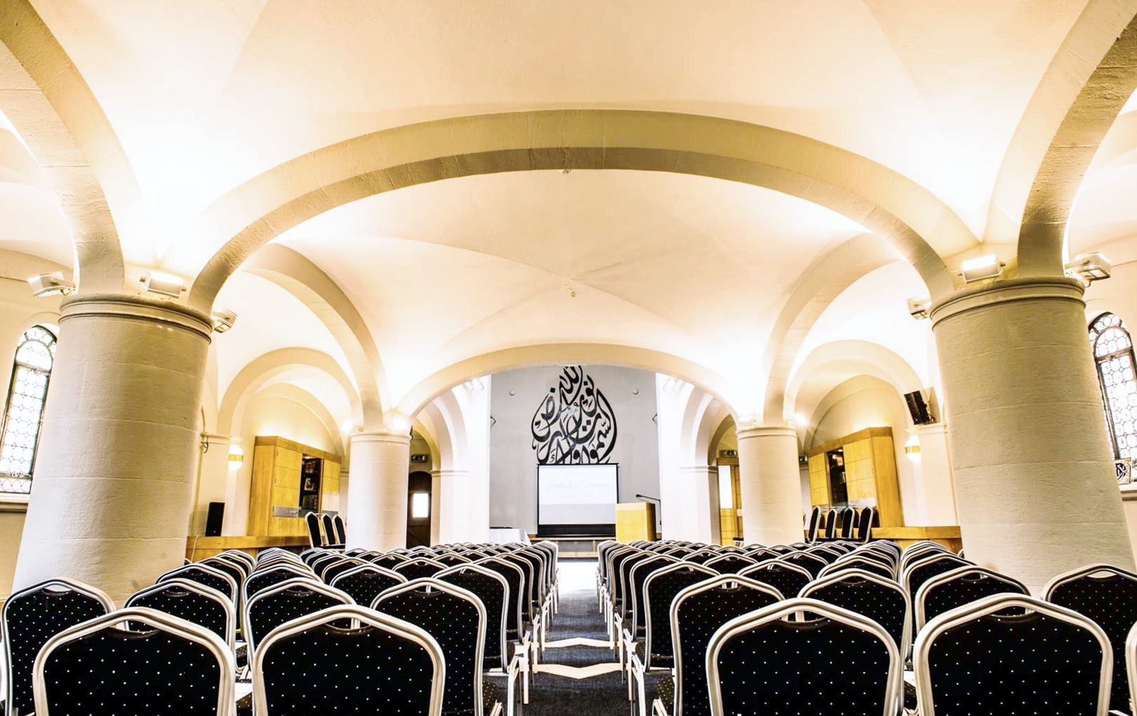 Elegant conference space with arranged chairs, ideal for meetings and seminars.