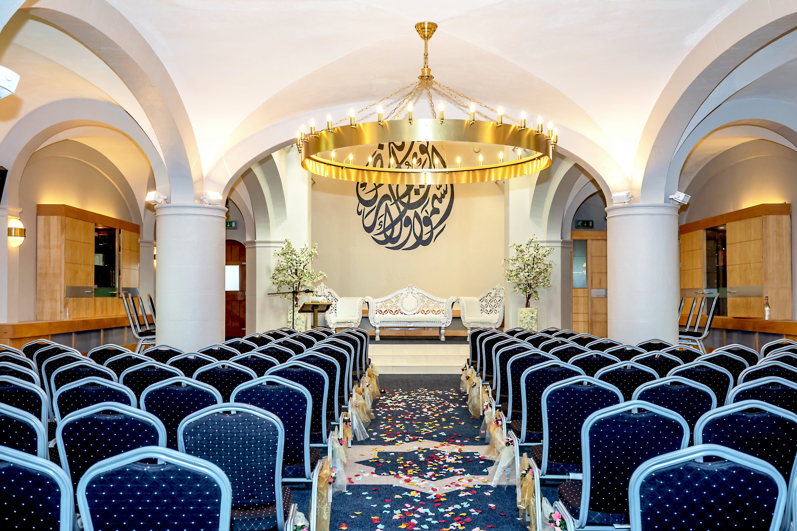 Elegant conference space with chandelier, perfect for meetings and weddings.