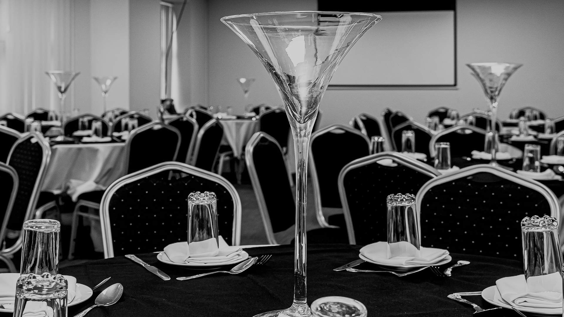 Sophisticated function room with elegant tables, ideal for formal events and presentations.