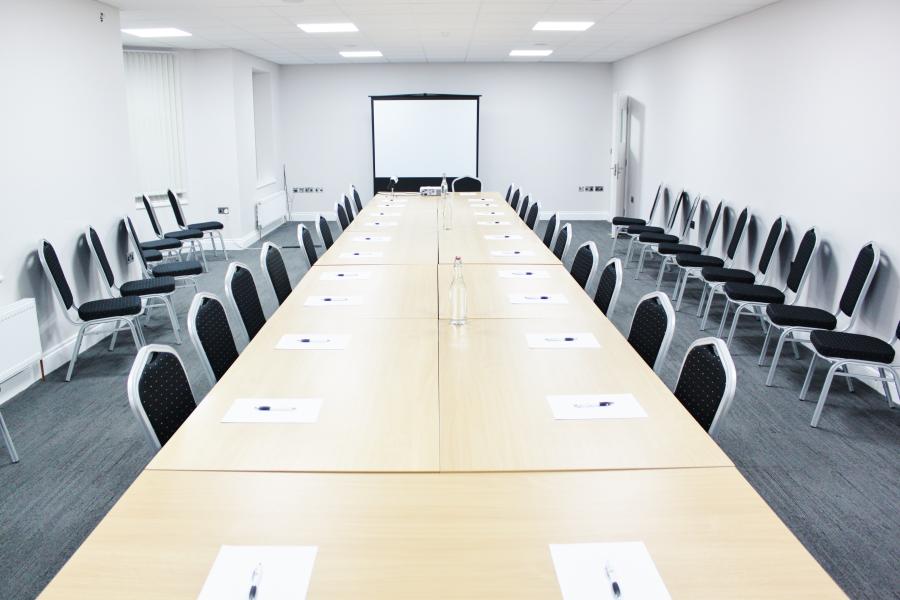 Function room in AMI Spaces, featuring a long table for professional workshops and meetings.