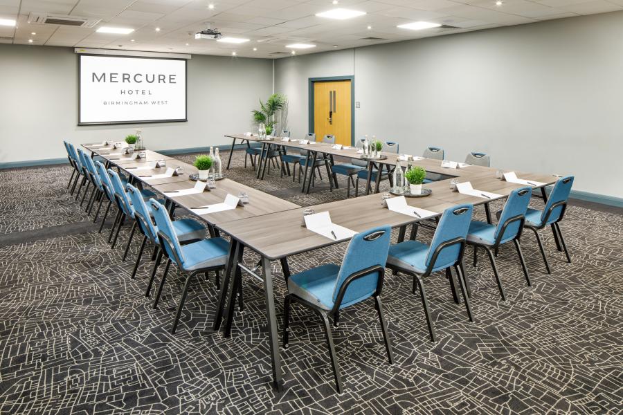 Conference Centre with U-shaped tables, ideal for corporate meetings and workshops.