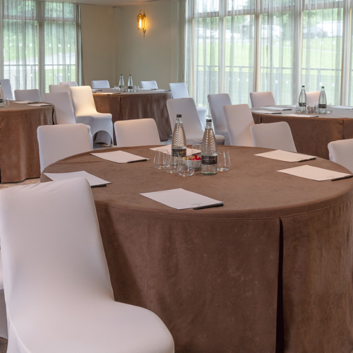 Upper Claret Jug meeting space with round tables, ideal for conferences and workshops.