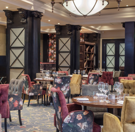 Upper Claret Jug dining space with floral chairs, ideal for corporate events and gatherings.