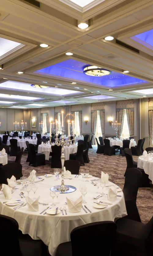 Elegant banquet hall at Oulton Hall with candelabras, perfect for weddings and corporate events.