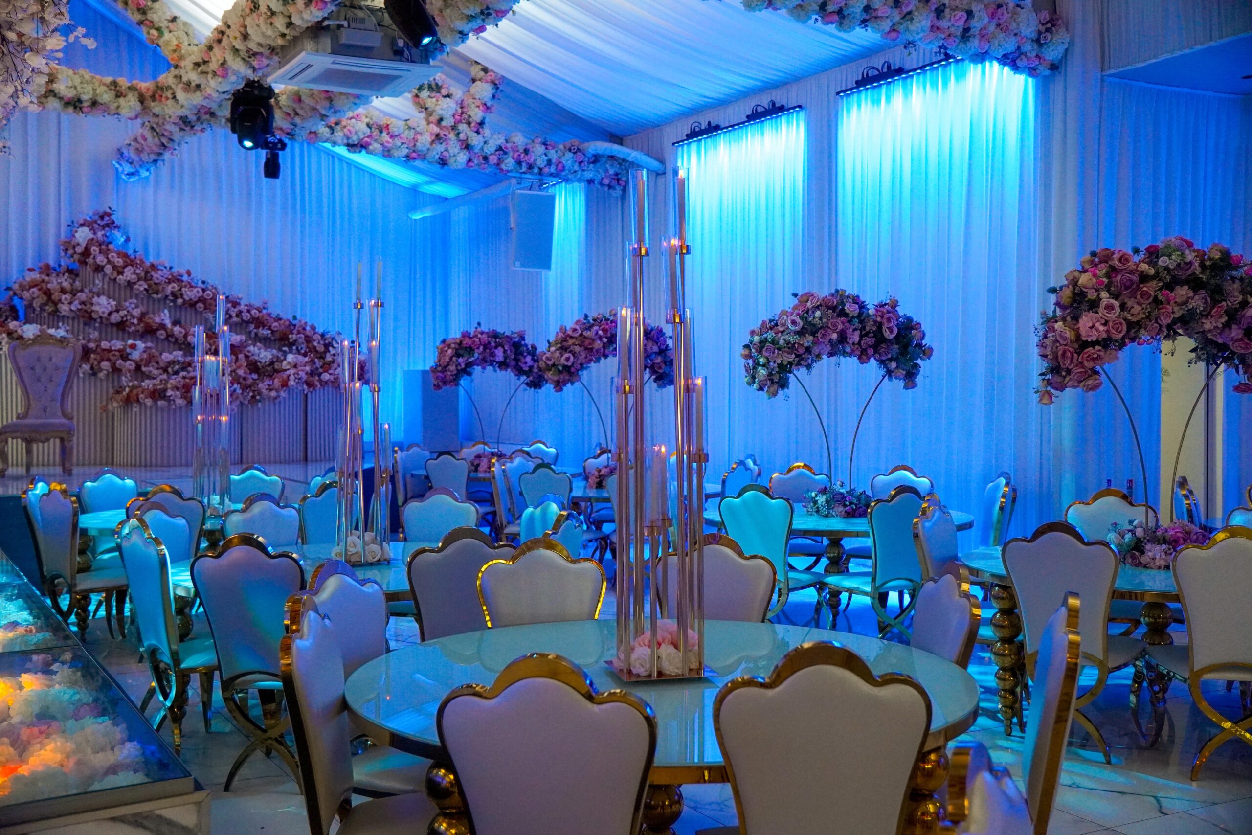 Elegant event space in Grand Botanical Suite with blue lighting, perfect for weddings.