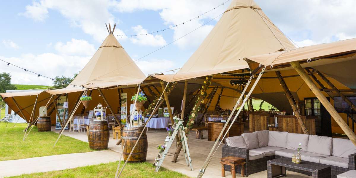 Outdoor wedding venue with elegant tipis and rustic decor for memorable events.