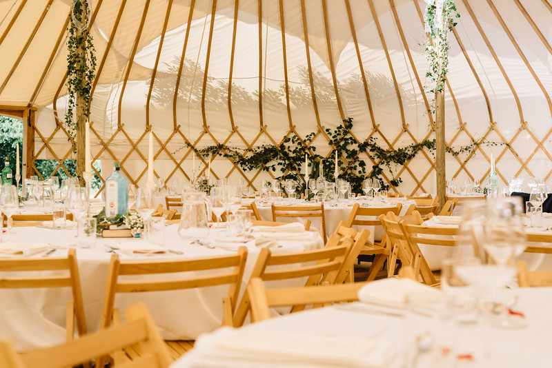 Elegant yurts at Alcott Weddings, featuring round tables and soft lighting for upscale events.