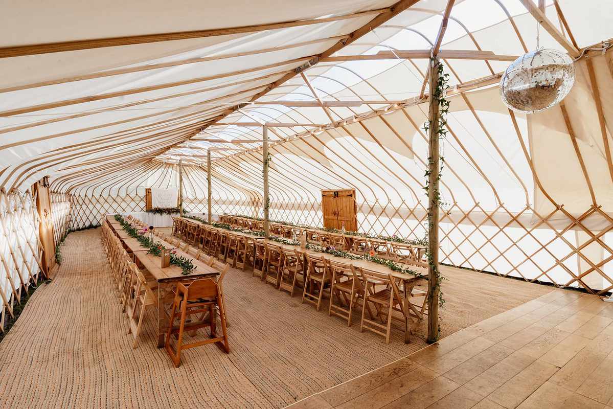Yurt event space with natural light, ideal for weddings and celebrations.