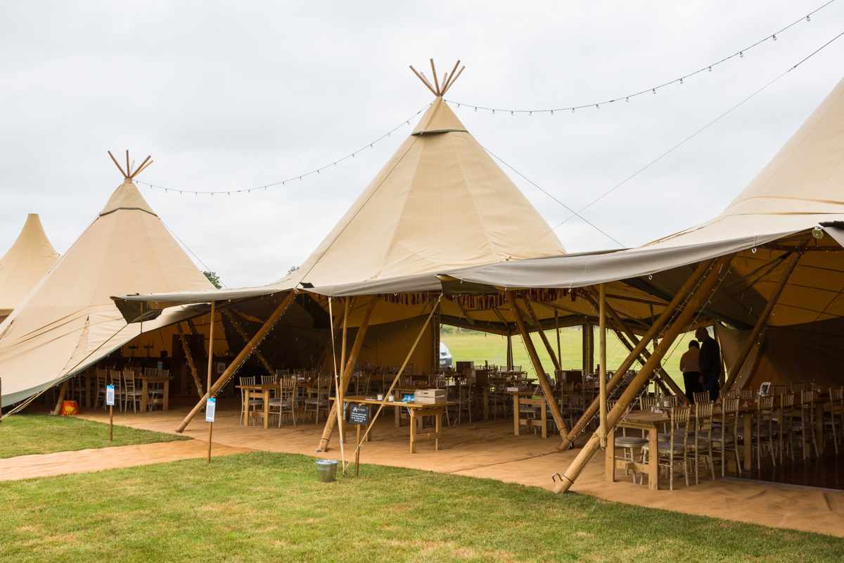 Tipis at Alcott Weddings with string lights, perfect for outdoor weddings and events.