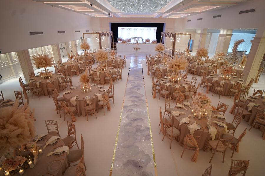 Elegant event space with round tables, ideal for weddings and upscale gatherings.