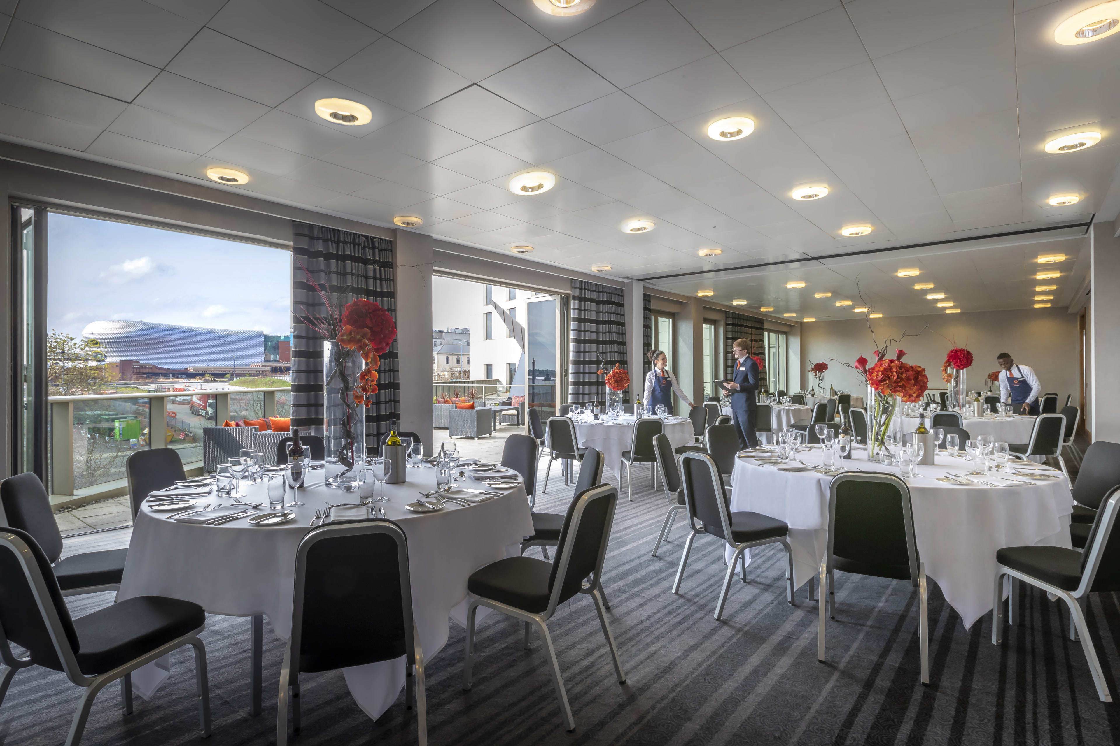 Elegant event space with round tables, ideal for corporate meetings and banquets.