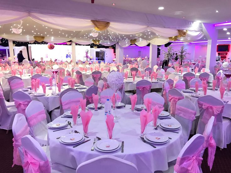 Elegant banquet hall with pink accents, perfect for weddings and formal events.