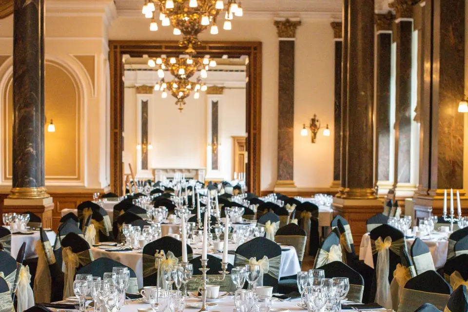 Elegant banquet hall with white linens, perfect for weddings and corporate events.