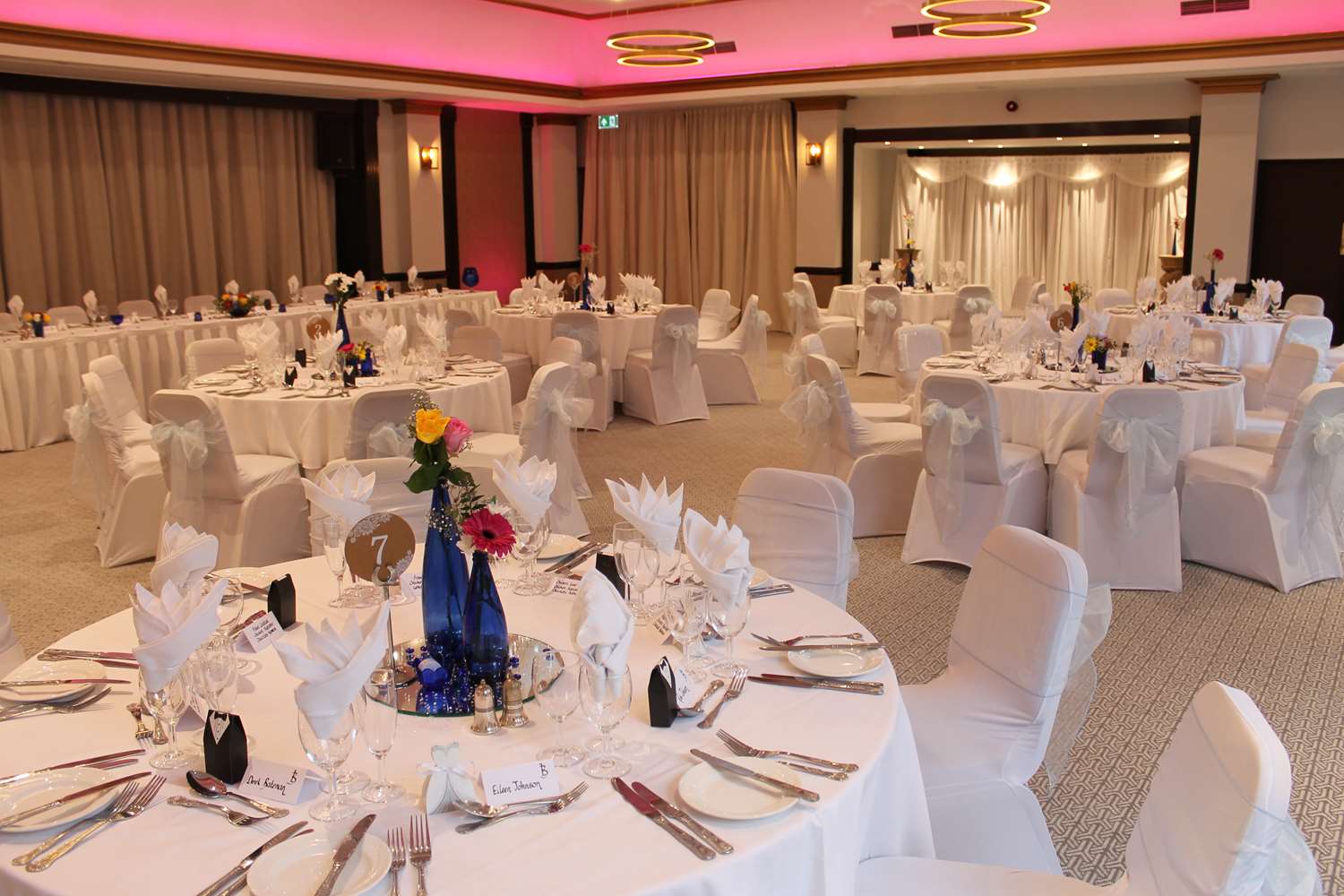 Elegant Shamas Hall banquet setup with white linens for weddings and corporate events.