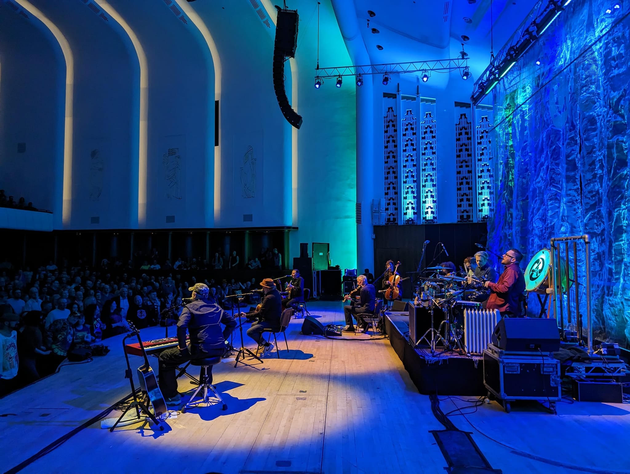 Vibrant live performance in spacious Stage Studios with dramatic lighting and engaged audience.