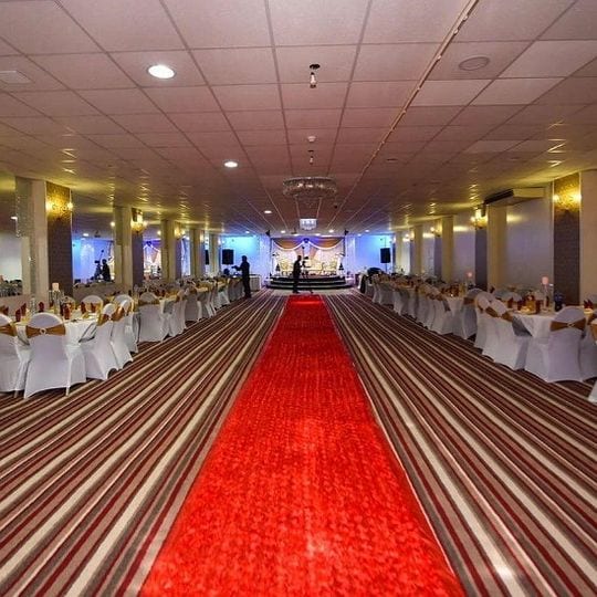 Elegant Banqueting Suite with round tables, ideal for weddings and formal gatherings.
