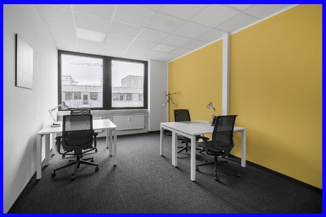 Modern meeting room with yellow accent wall for team collaborations in Birmingham.