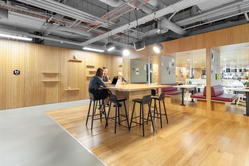 Modern cafe workspace with communal table for meetings and events in Lewis Building.