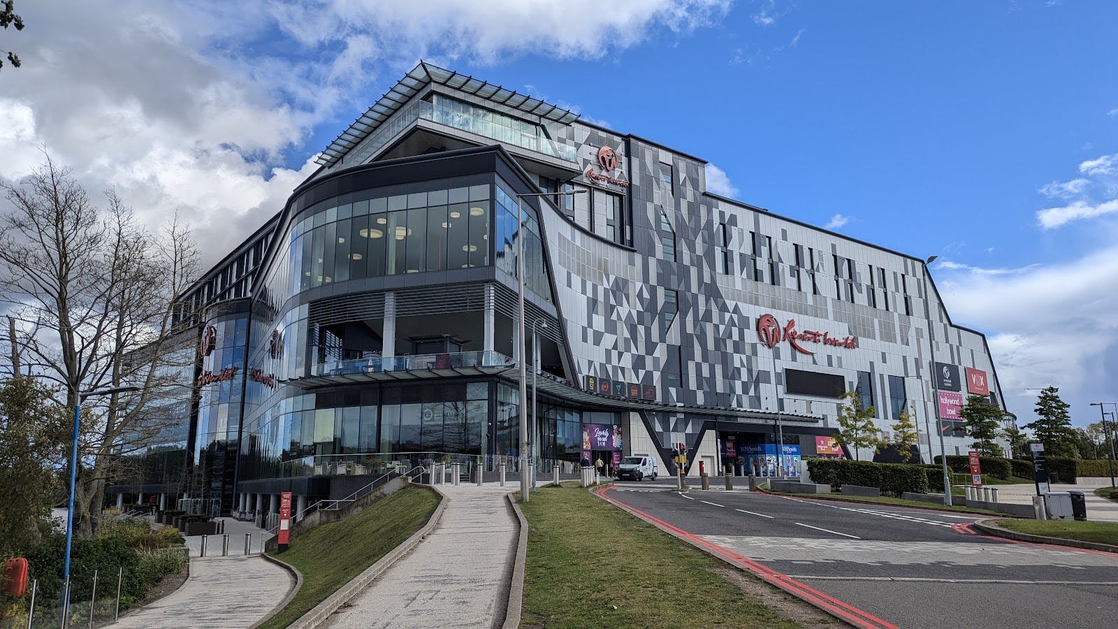 Modern NEC Birmingham auditorium with glass facade, perfect for conferences and exhibitions.