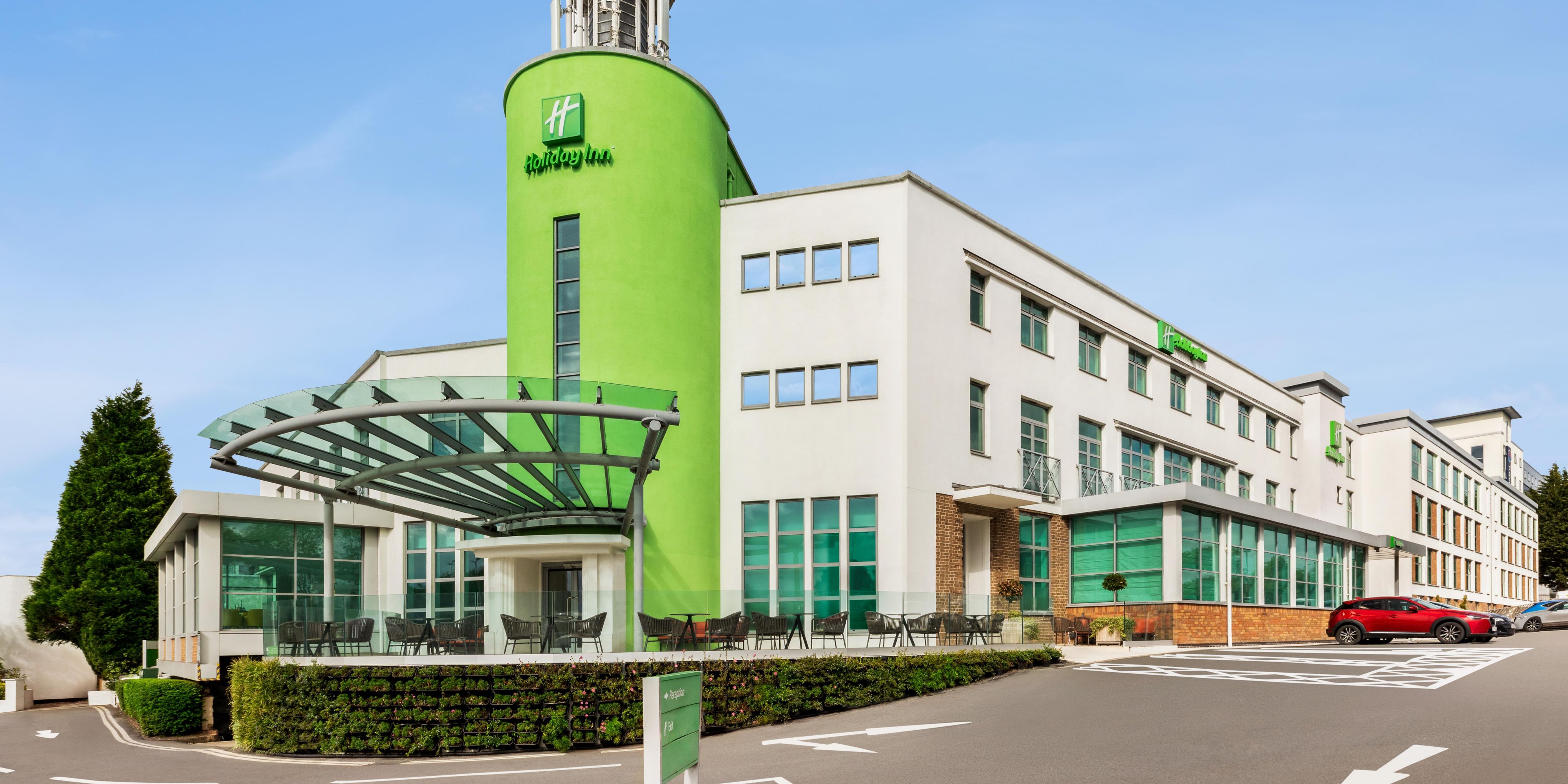 Modern hotel exterior at The NEC Birmingham, vibrant green, ideal for meetings and events.