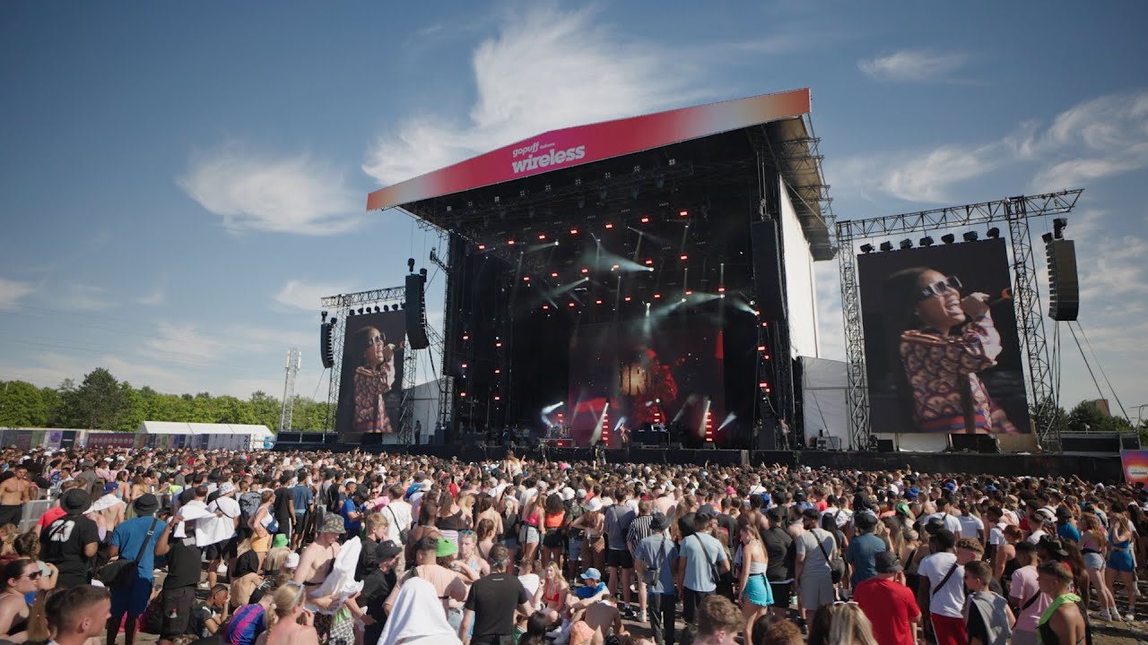 Vibrant outdoor concert at The NEC Birmingham with large crowd and impressive stage.