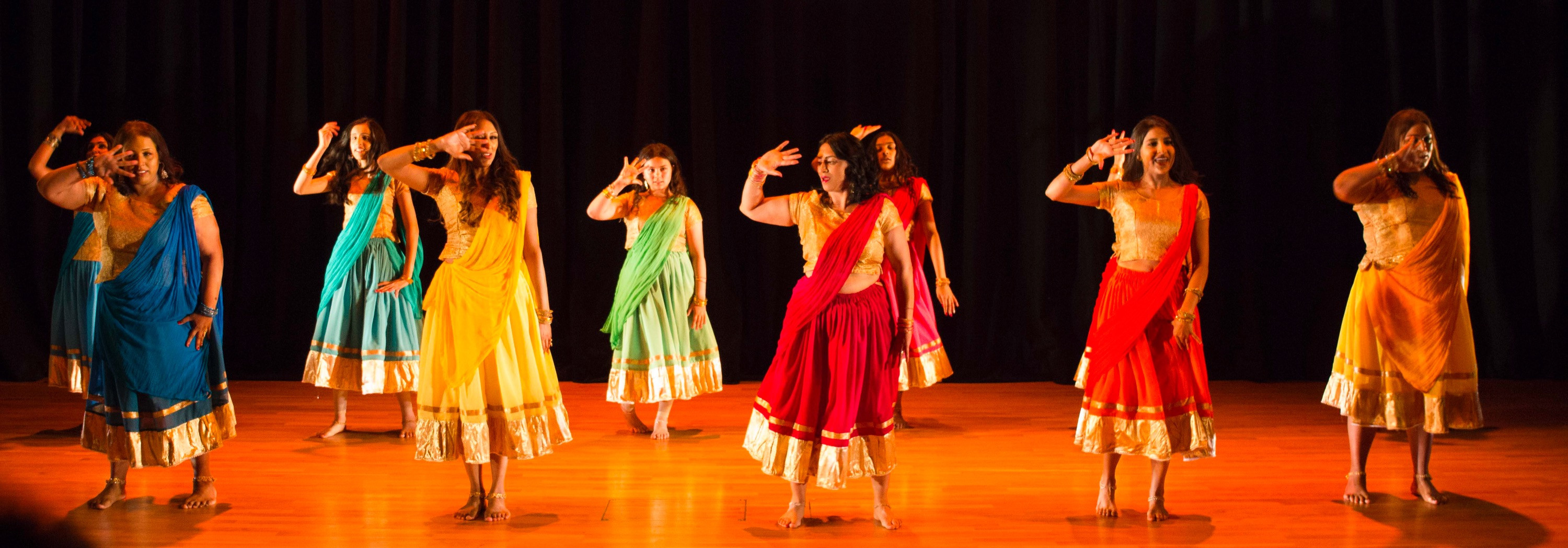Vibrant dance studio performance with colorful traditional attire for cultural events.