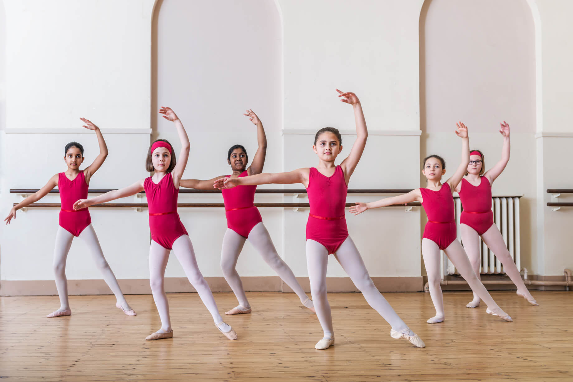 Young dancers in red leotards at Ground-Floor Bar, Rutleigh Norris School of Dance.