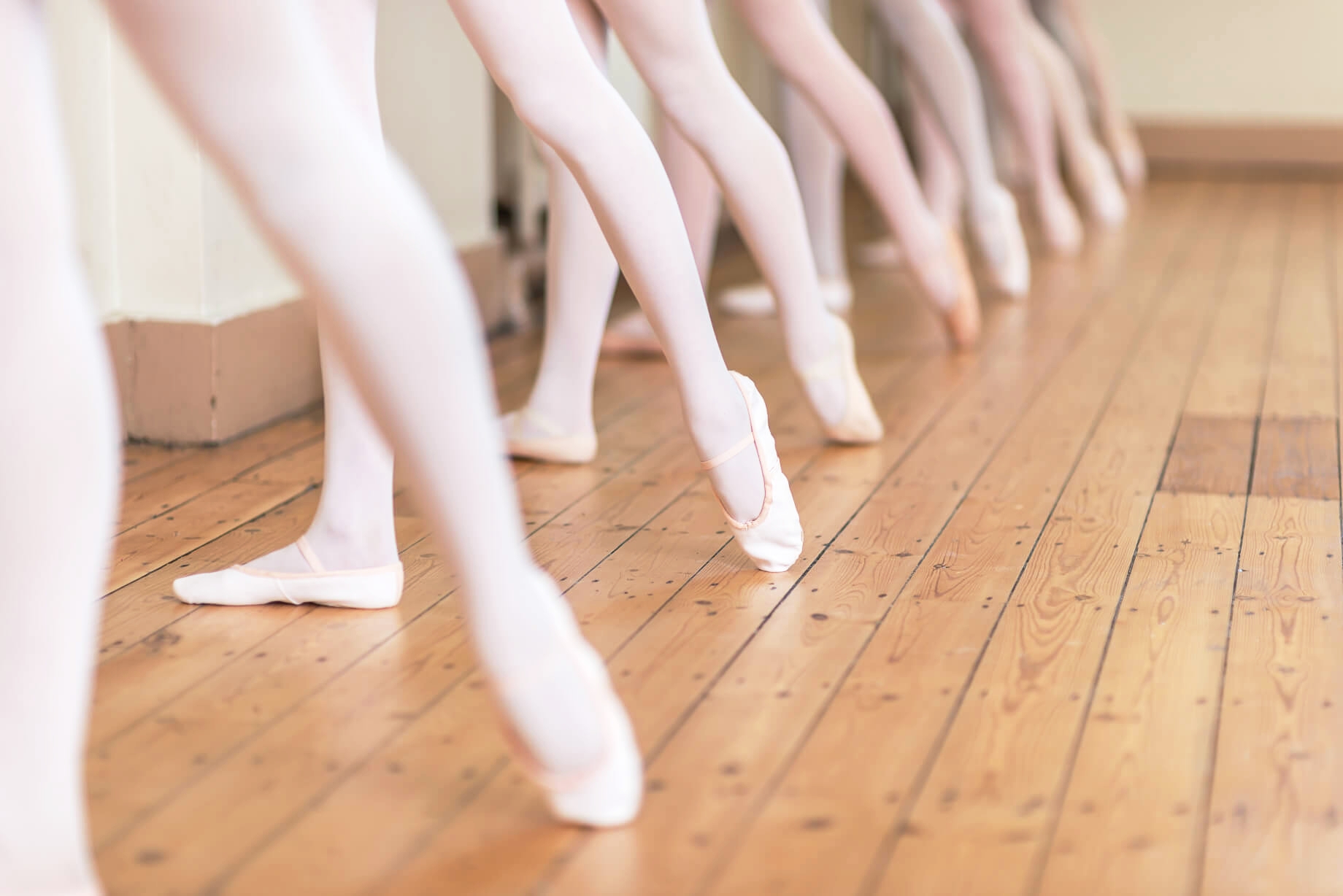 Ballet dancers practicing in Rutleigh Norris School of Dance's Main Foyer, showcasing teamwork.