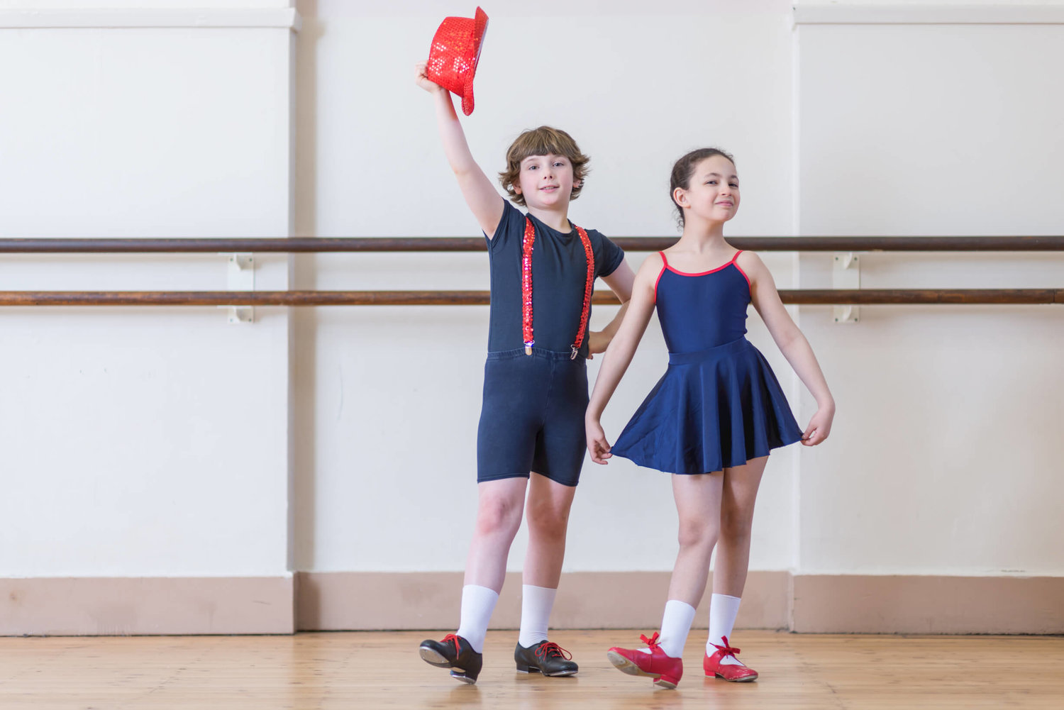 Young dancers in Rutleigh Norris School of Dance foyer, showcasing energy and creativity.