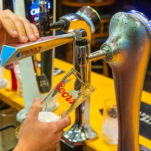 Bartender pouring draft beer at Main Bar, enhancing event atmosphere and guest experience.