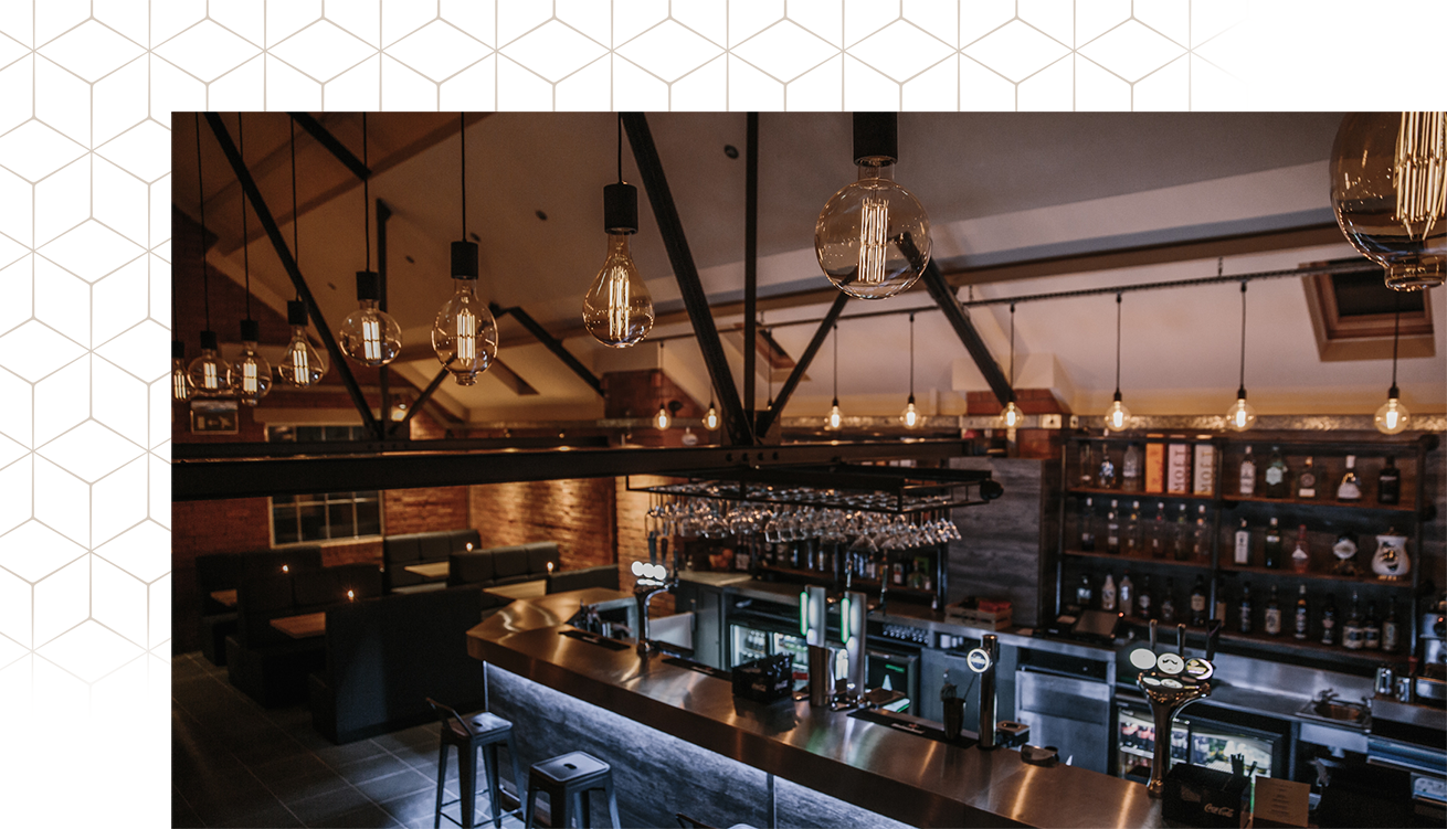 Stylish bar area at Brick & Beam, perfect for networking events and gatherings.