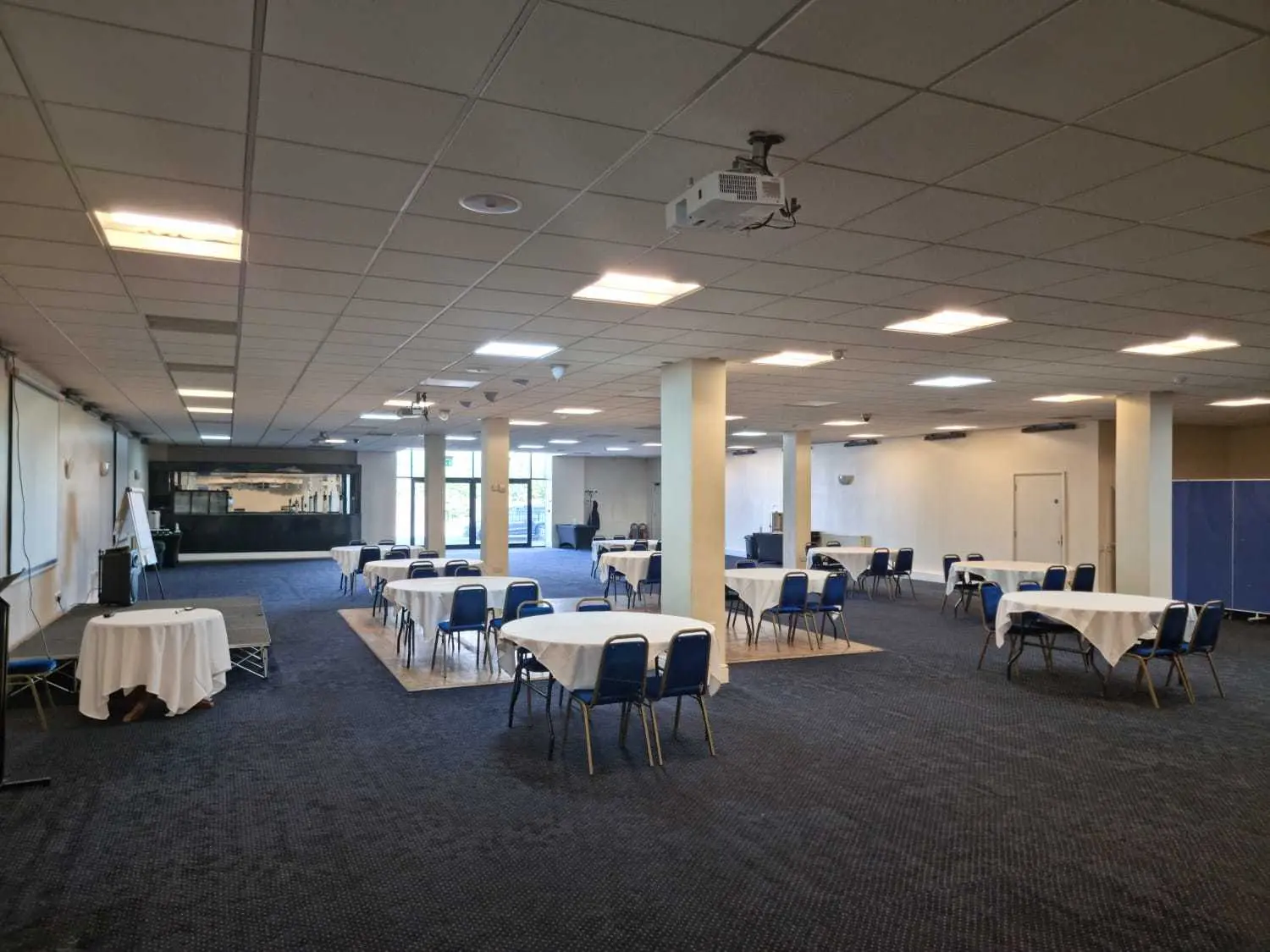 Spacious conference center with round tables, ideal for corporate meetings and workshops.